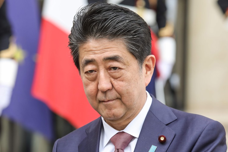 Japanese Prime Minister Shinzo Abe addresses the media as he arrives for a meeting with French President in the courtyard of the Elysee presidential Palace in Paris on April 23, 2019. (Photo by ludovic MARIN / AFP)