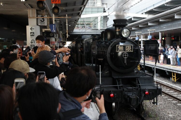 先頭部に「無限」のナンバープレートが付け替えられた鬼滅仕様の蒸気機関車も登場（時事通信フォト）