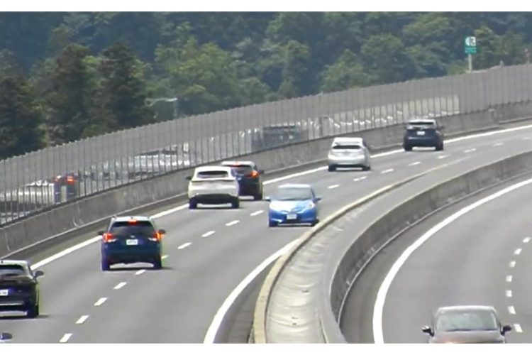 5月18日、車列が続く高速道路を逆走する青い車がカメラにとらえられた(NXCO中日本名古屋支社提供/時事通信フォト)