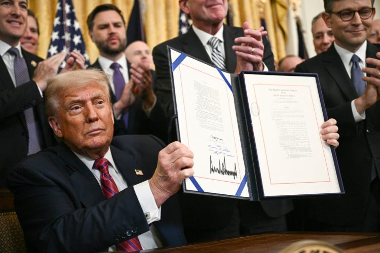 「ステーブルコイン」の規制整備に関する法案に署名したトランプ米大統領(写真:AFP=時事)